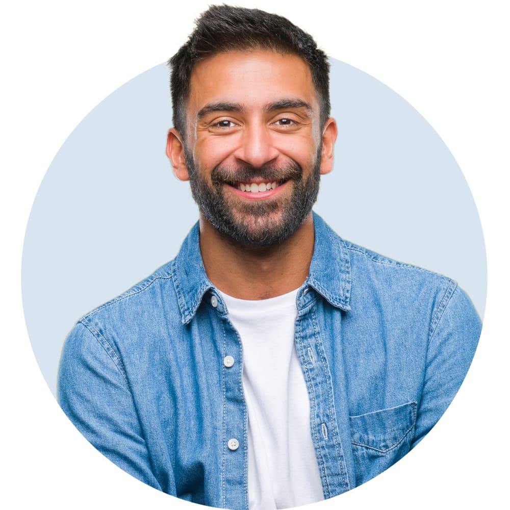 A man in a blue shirt is smiling.