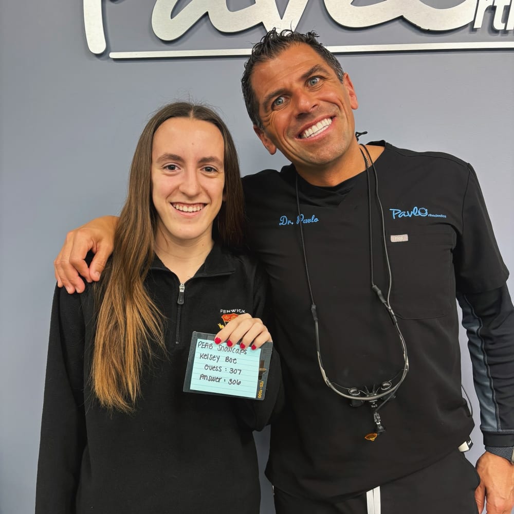 Dr. Pavlo smiles with a patient at Pavlo Orthodontics.