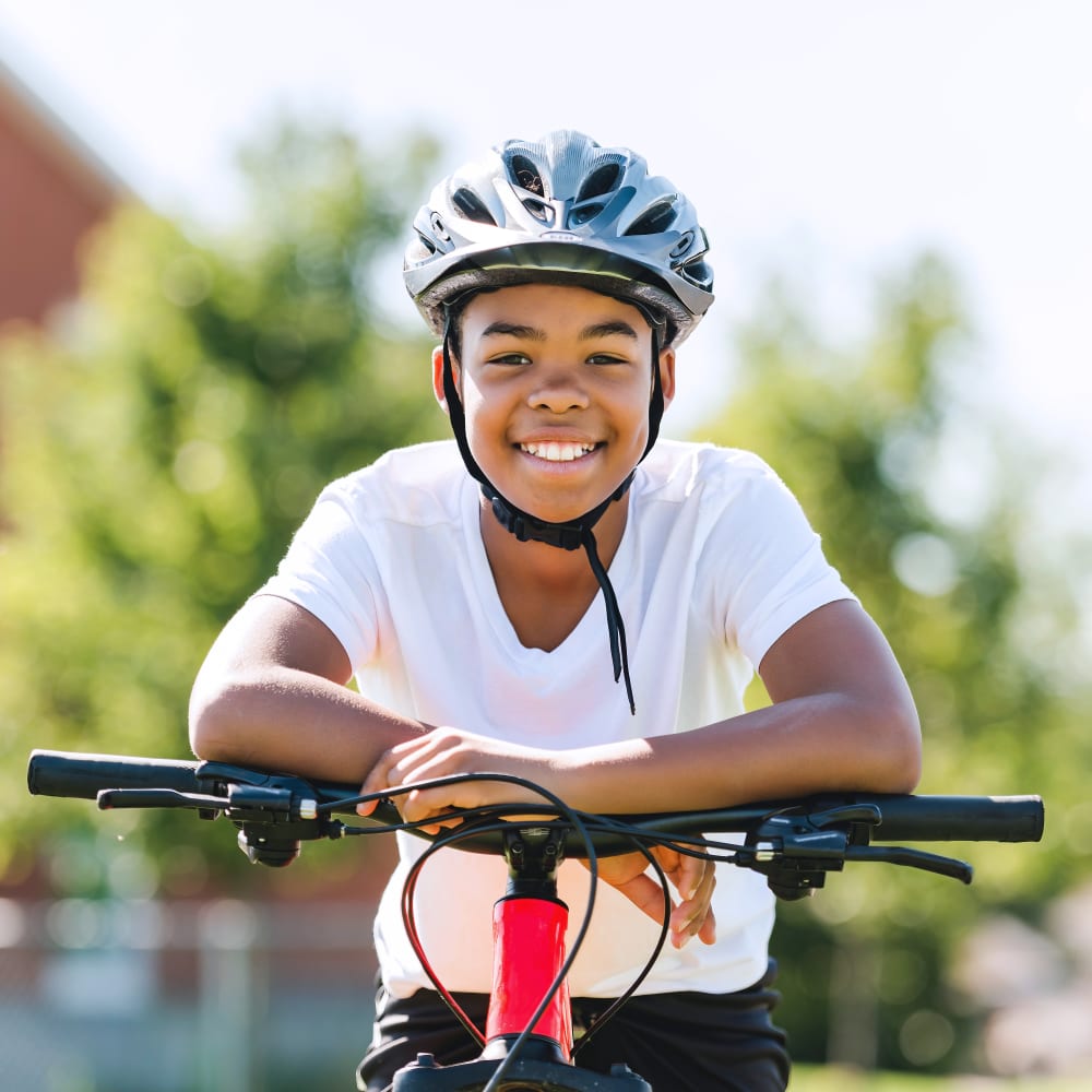 A young boy rides a bike.